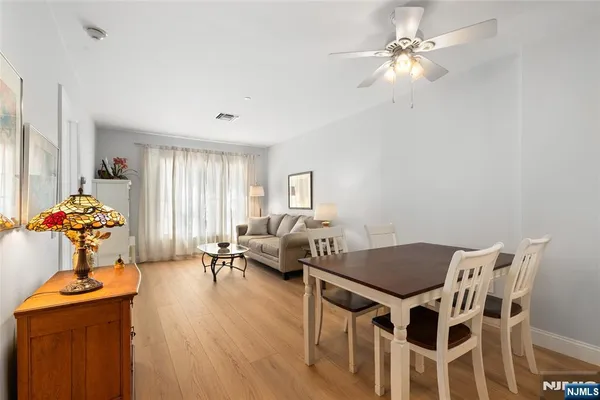 a view of a dining room with furniture wooden floor and chandelier