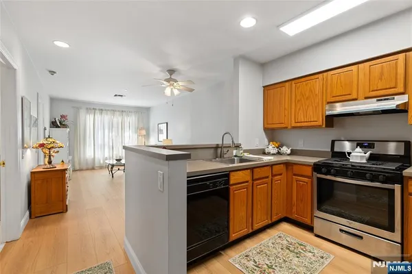 a kitchen with stainless steel appliances granite countertop a stove sink and cabinets
