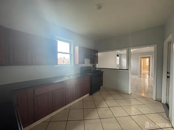 a kitchen with cabinets and a refrigerator