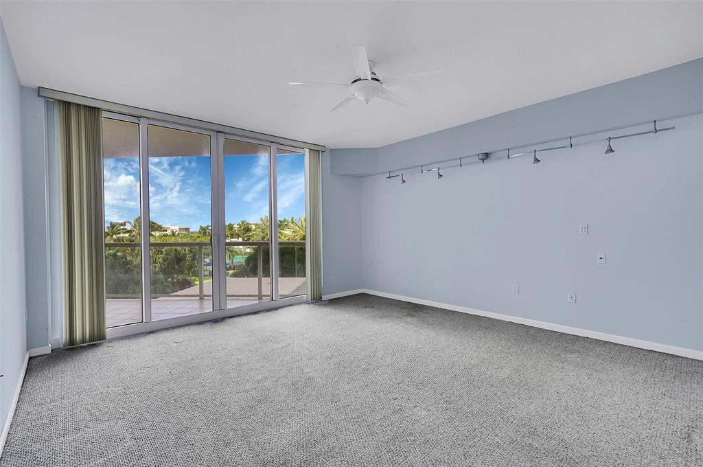 6001 North Ocean Drive, Unit 403 Hollywood, FL 33019 - Photo 14 of 58 a view of an empty room with wooden floor and a sliding door