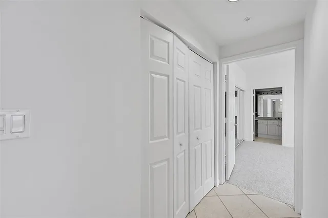 a spacious bedroom with a large bed and a chandelier