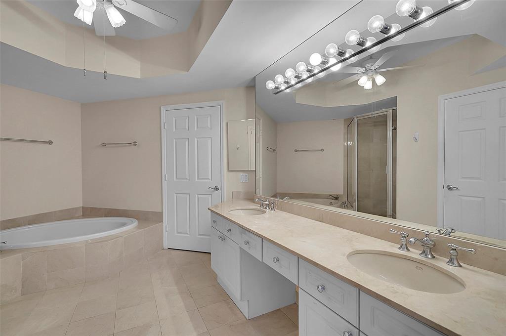 6001 North Ocean Drive, Unit 403 Hollywood, FL 33019 - Photo 18 of 58 a spacious bathroom with a granite countertop sink a large mirror and a bathtub