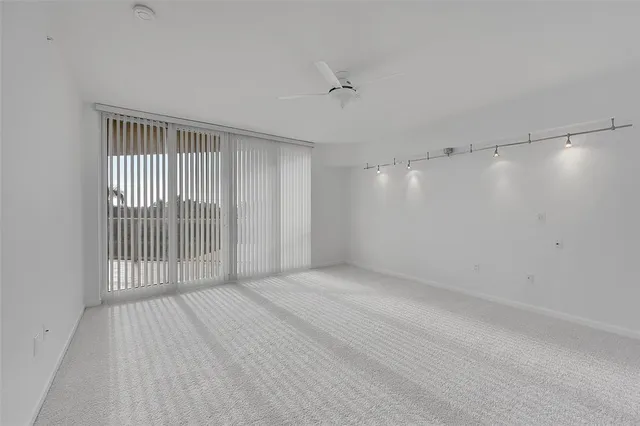 a view of a livingroom with wooden floor and a window