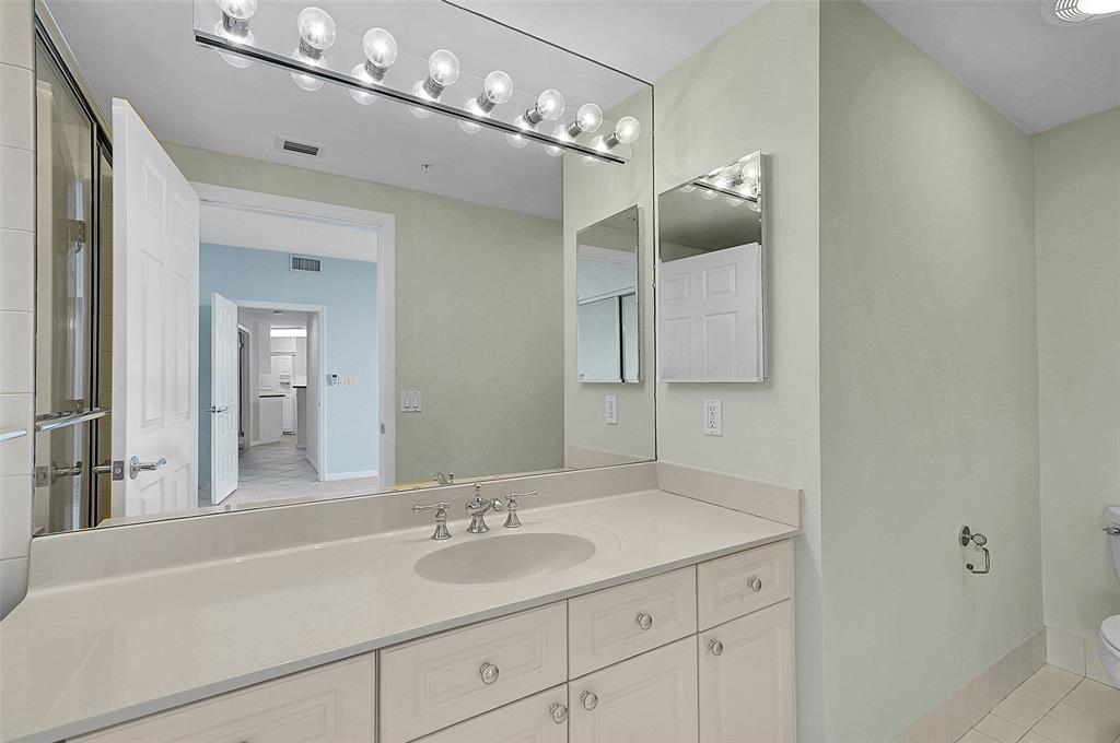 6001 North Ocean Drive, Unit 403 Hollywood, FL 33019 - Photo 27 of 58 a bathroom with a sink vanity and mirror