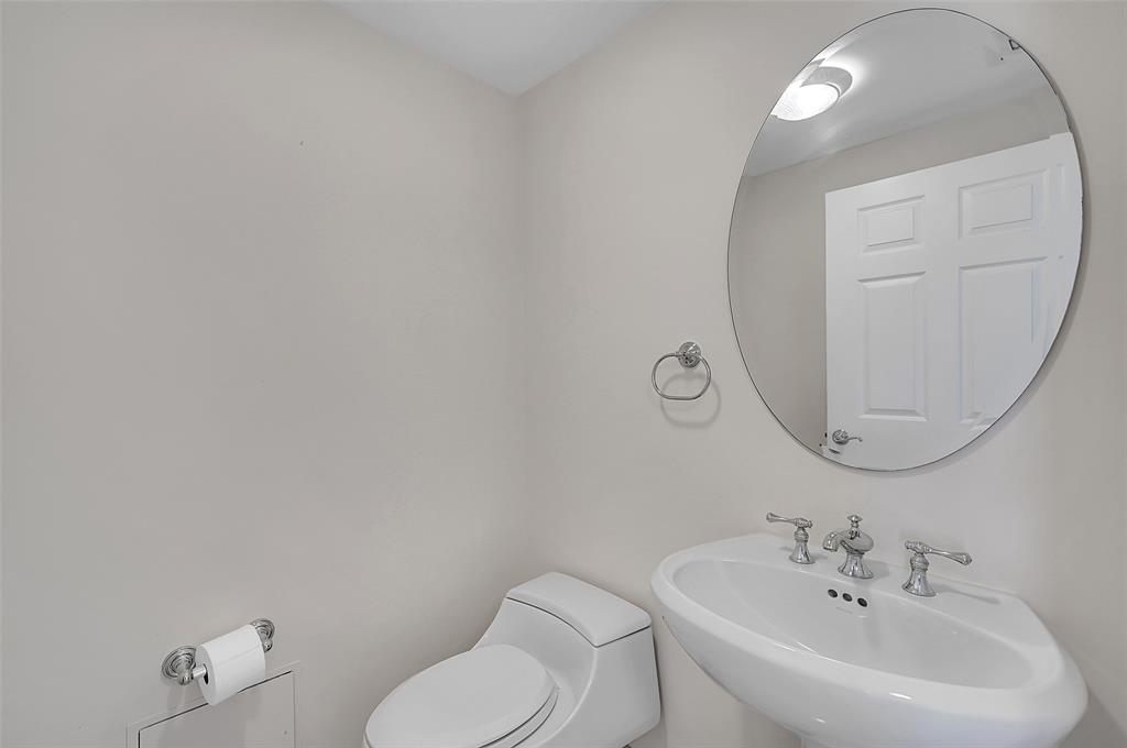 6001 North Ocean Drive, Unit 403 Hollywood, FL 33019 - Photo 32 of 58 a bathroom with a toilet sink and mirror