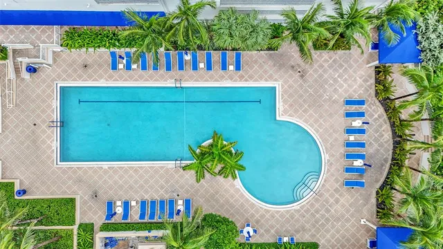 a swimming pool with outdoor seating and yard