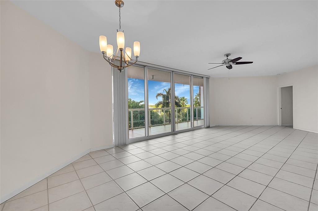 6001 North Ocean Drive, Unit 403 Hollywood, FL 33019 - Photo 4 of 58 a view of a livingroom with a chandelier fan and windows