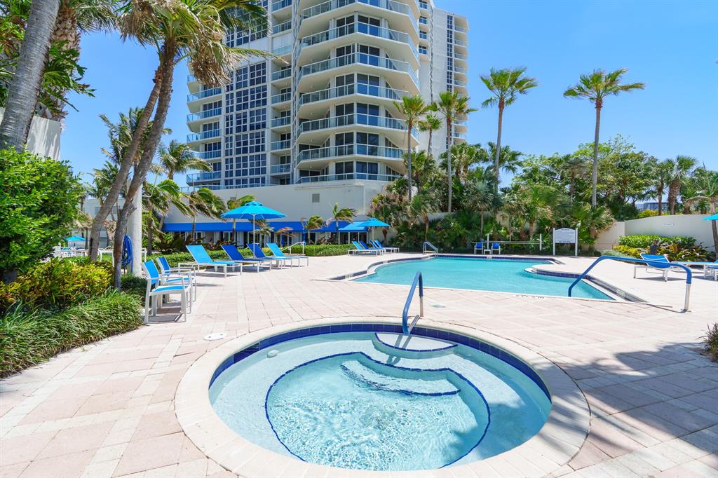 6001 North Ocean Drive, Unit 403 Hollywood, FL 33019 - Photo 41 of 58 a swimming pool with outdoor seating yard and trees