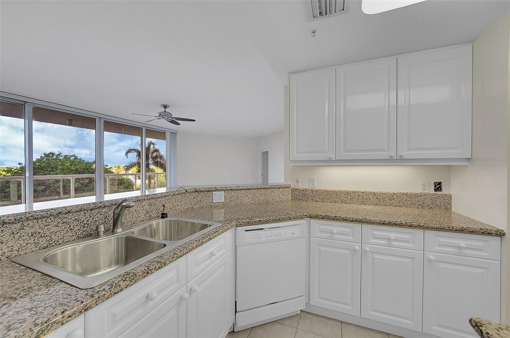 6001 North Ocean Drive, Unit 403 Hollywood, FL 33019 - Photo 10 of 58 a kitchen with a sink and cabinets