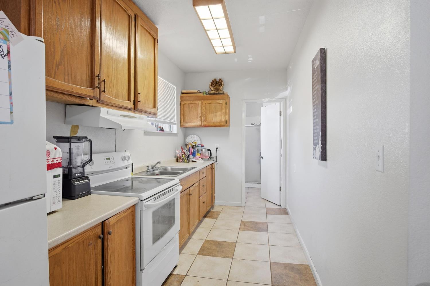 6176 Fleming Road Atwater, CA 95301 - Photo 17 of 41 a kitchen with stainless steel appliances granite countertop a sink stove and refrigerator