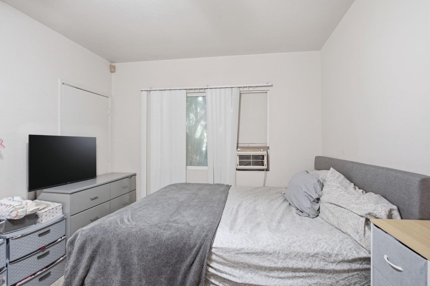 6176 Fleming Road Atwater, CA 95301 - Photo 23 of 41 a bedroom with a bed and a flat screen tv