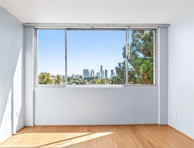 a view of a balcony with wooden floor and fence