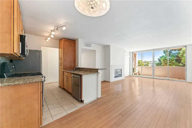 a kitchen with a stove a refrigerator and a fireplace