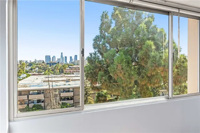 a view of a glass door with a city from a window