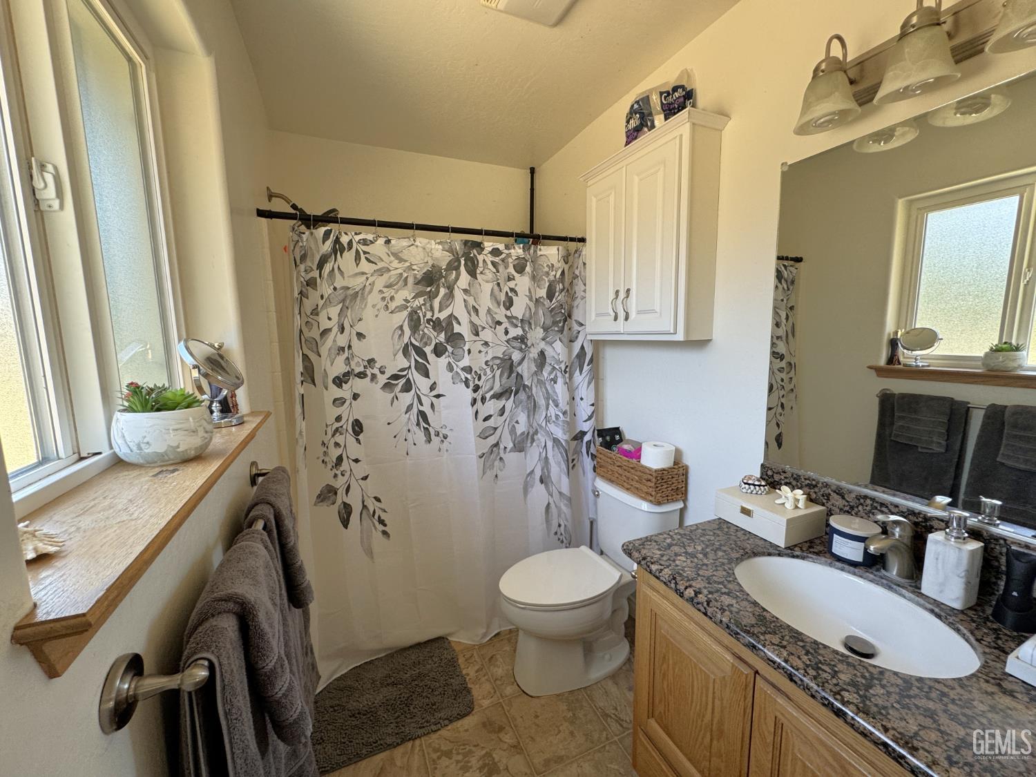 Undisclosed Address Tehachapi, CA 93561 - Photo 13 of 16 a bathroom with a granite countertop sink toilet and shower