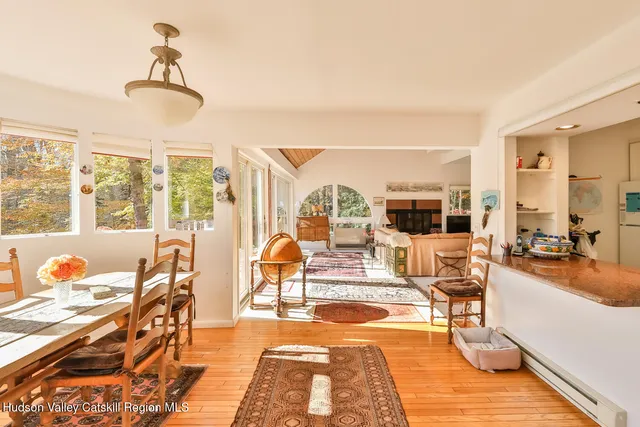 a living room with furniture a rug and white walls