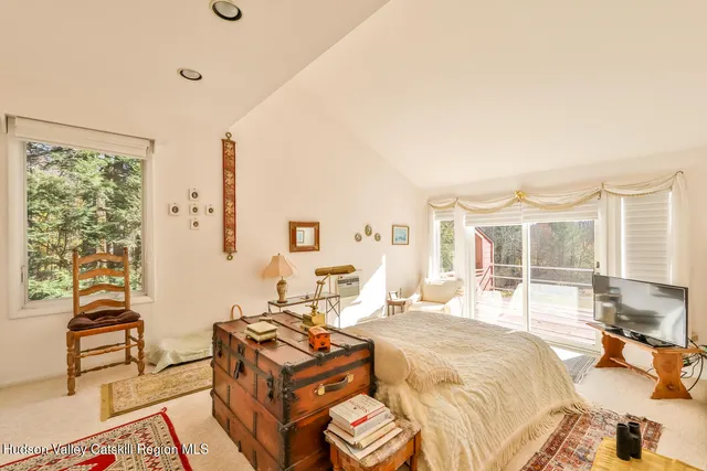 a bedroom with a bed and a large window