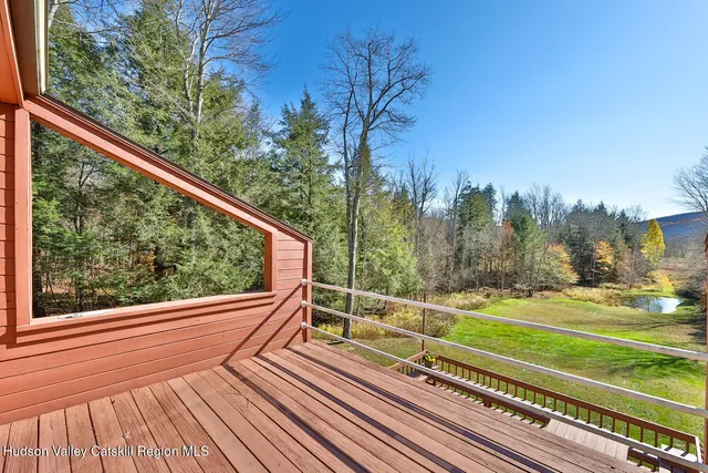 a view of a yard with wooden floor and fence