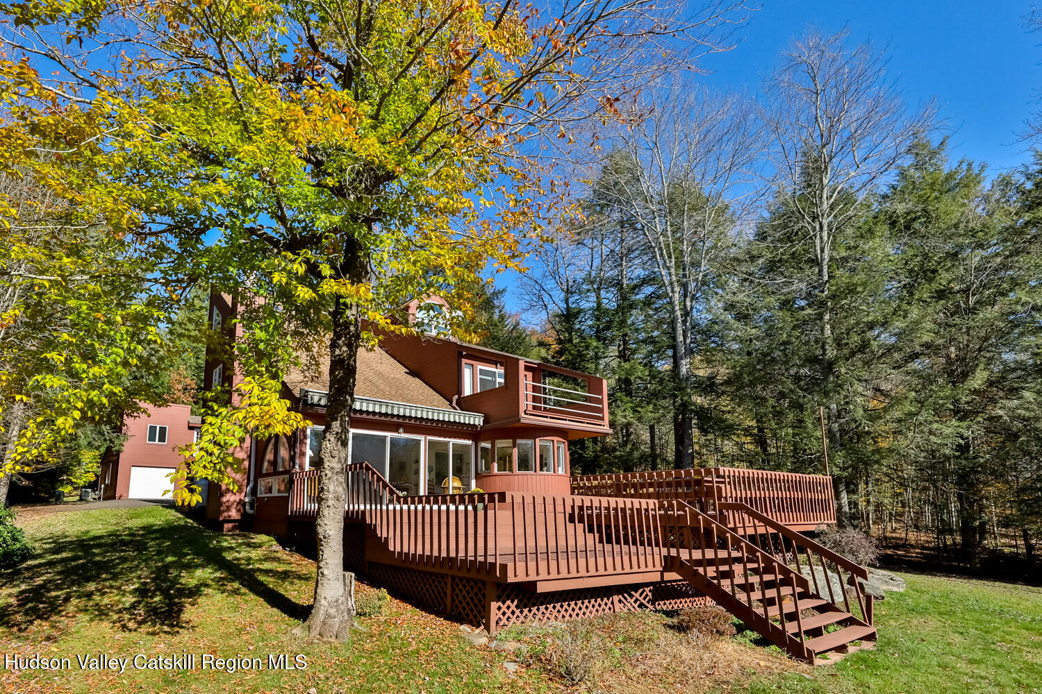 91 Beaver Hill Road Windham, NY 12496 - Photo 35 of 35 a view of a brick house with a small yard and wooden fence