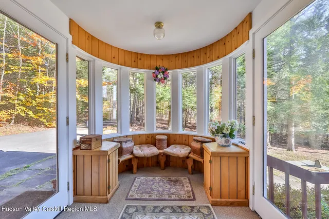 a living room with furniture and a floor to ceiling window