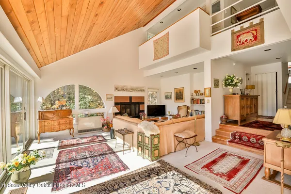 a living room with furniture a rug and a fireplace