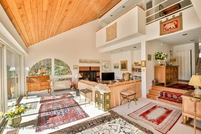 a living room with furniture a rug and a fireplace