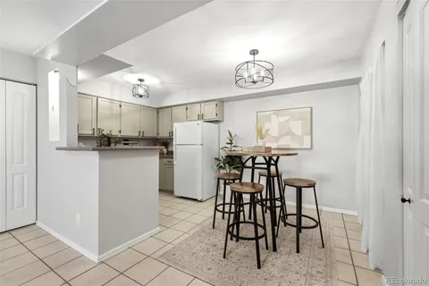 a kitchen with refrigerator and table
