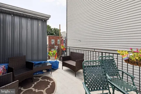 a view of a patio with a table and chairs