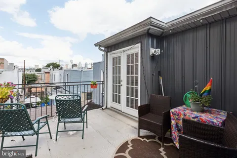 a balcony with furniture and a potted plant