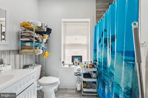 a bathroom with a sink toilet and shower