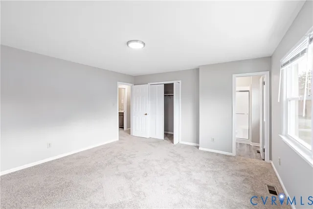 a view of an empty room and a window