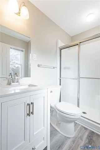 a bathroom with a toilet a sink and a large mirror