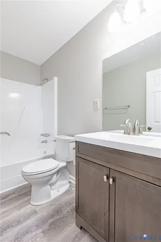 a bathroom with a sink toilet and a mirror