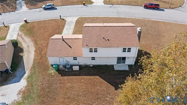 an aerial view of a house with a yard