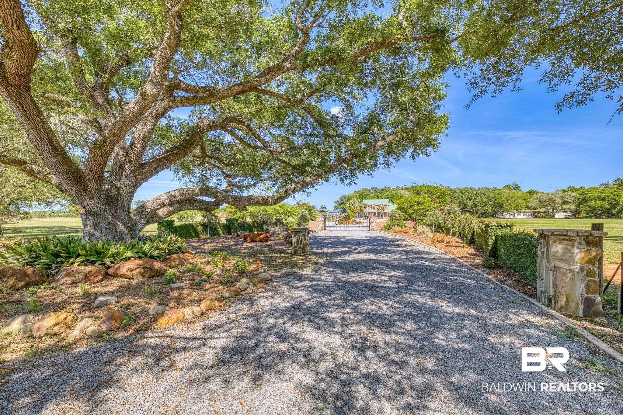 32875 Faircloth Road Lillian, AL 36549 - Photo 4 of 85 View of dirt / gravel driveway featuring a gated entry and a gate
