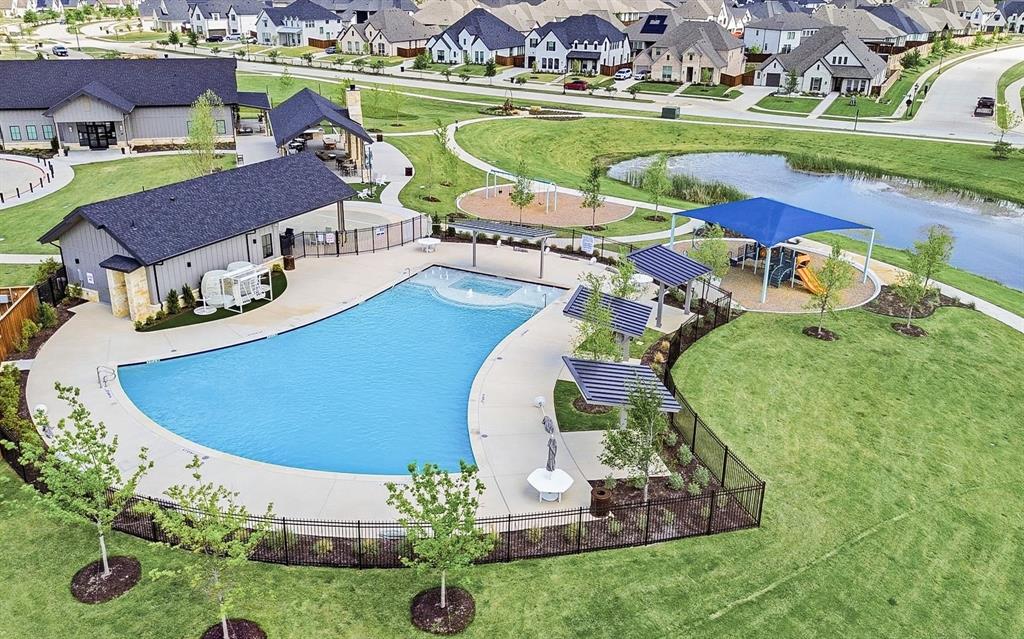 1309 Old Rocksprings Pass Mansfield, TX 76063 - Photo 36 of 36 Community amenities featuring a large resort-style swimming pool, covered lounge areas, and a children's play structure with shade canopy