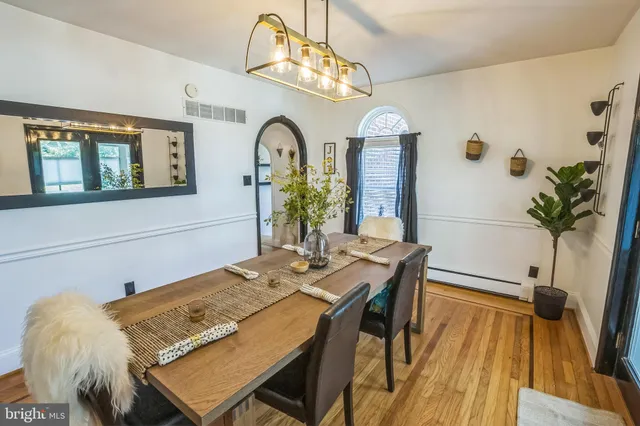 a view of a dining room with furniture and a chandelier