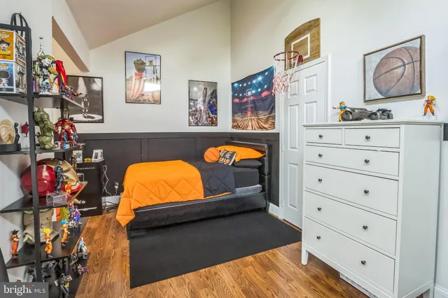 a view of a bedroom with baby bed and window