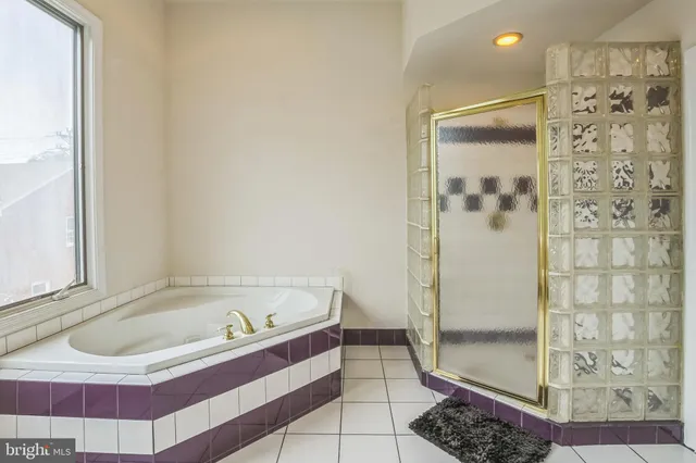 a bathroom with a bathtub and shower