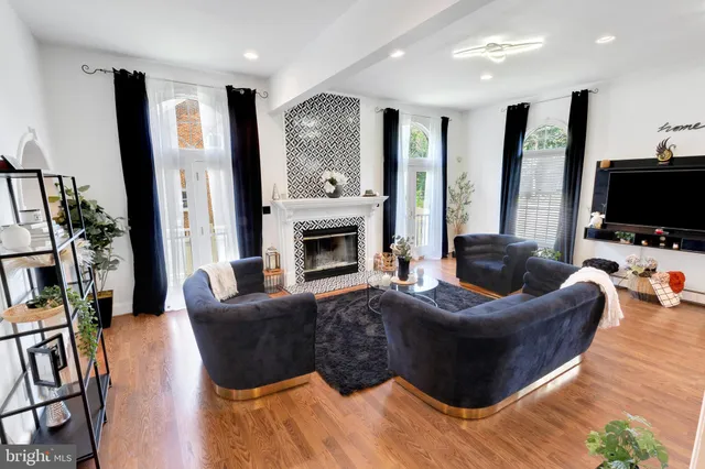 a living room with furniture a flat screen tv and a fireplace