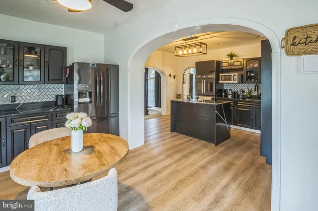 a kitchen with stainless steel appliances granite countertop a sink and a refrigerator