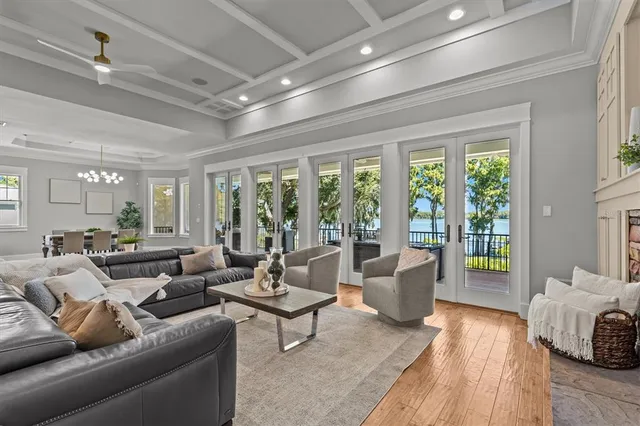 a living room with furniture and a chandelier