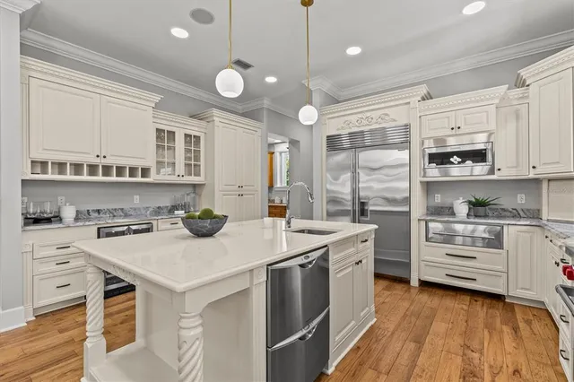 an empty room with wooden floor closet and windows