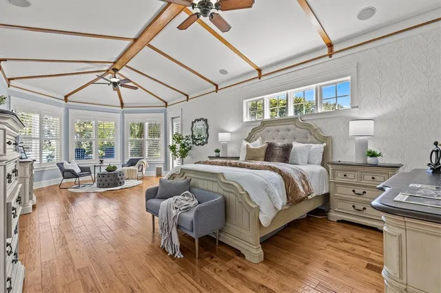 a bedroom with a large bed and a chandelier
