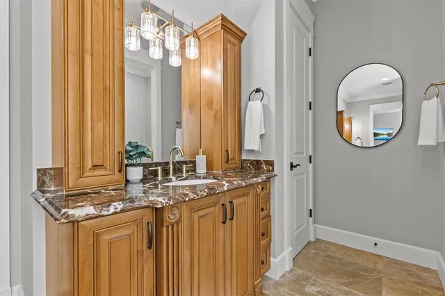 a kitchen with a refrigerator a sink dishwasher a stove and a dining table with wooden floor