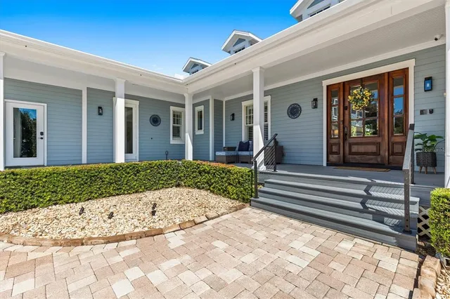 a bedroom with furniture and a floor to ceiling window