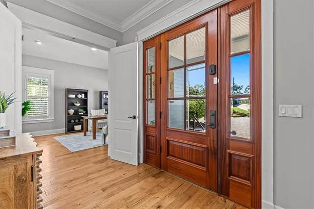 a living room with couches and a view of kitchen