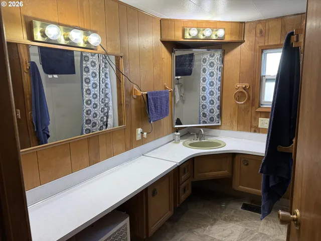 a bathroom with a sink a mirror and a shower