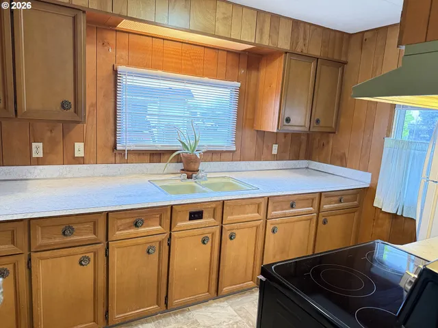 a kitchen with stainless steel appliances granite countertop a sink stove and cabinets