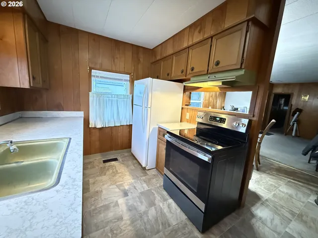 a kitchen with wooden cabinets and a stove top oven